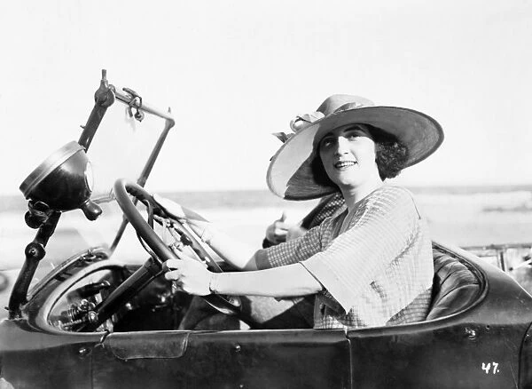 WOMAN DRIVING, c1921. A woman driving a car, c1921