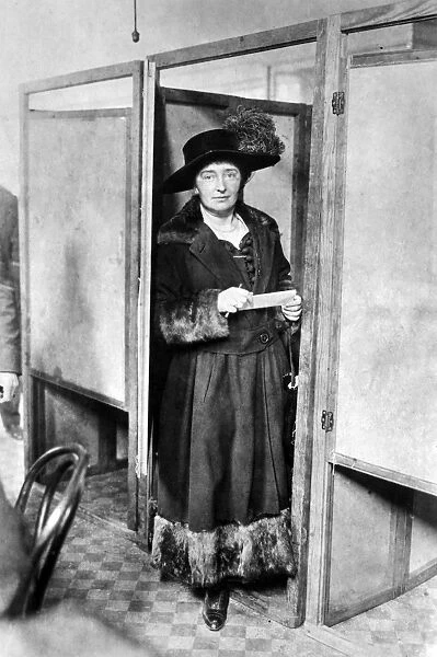 WOMAN: VOTING, 1920. An unidentified woman with her ballot at a voting booth in New York City, 1920