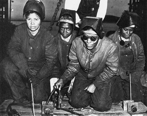 Women welders at a shipyard in Richmond, California, at work on the construction of the Liberty ship S. S. George Washington Carver, 1943. Photographed by E. F. Joseph