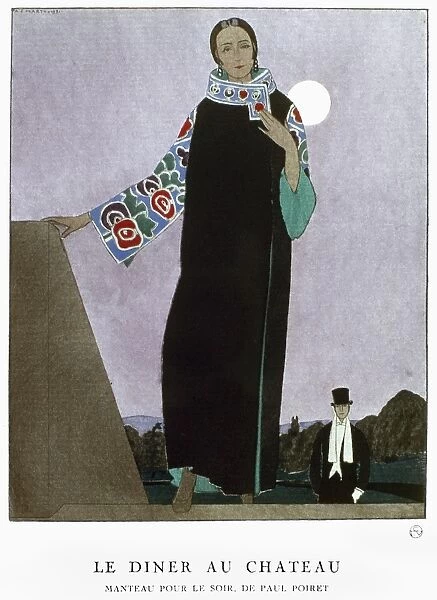 WOMENs FASHION, 1921. A woman wearing an evening coat designed by Paul Poiret
