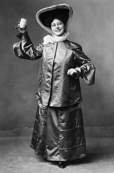 WOMENs FASHION, c1905. A motoring outfit of sized taffeta. Photograph c1905