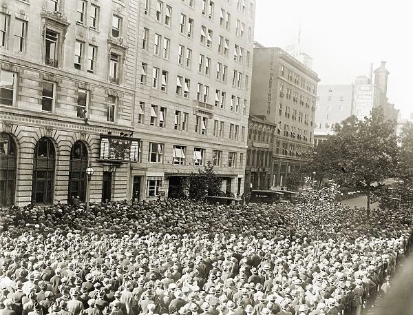 WORLD SERIES, 1925. A crowd of baseball fans watching a scoreboard on a street in Washington, D. C. during the 1925 World Series between the Pittsburgh Pirates and the Washington Senators, October 1925