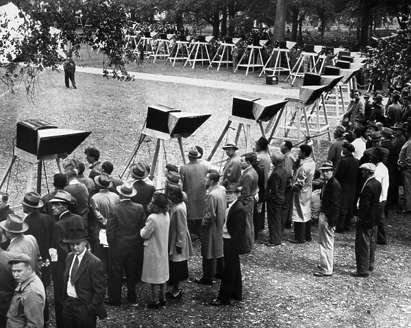 WORLD SERIES, 1948. People gathered around some of the 100 television sets installed on Boston Common to watch a broadcast of Game 1 of the 1948 World Series between the Boston Braves and the Cleveland Indians, 6 October 1948