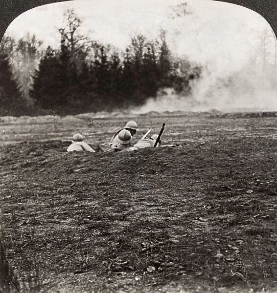 WORLD WAR I: MARNE, 1918. French soldiers in a shell hole behind a smoke screen