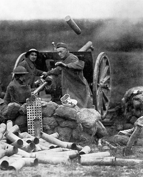 WORLD WAR I: U. S. ARTILLERY. An American gun crew fires a 75mm gun at Saint-Mihiel, France. Photograph, September 1918