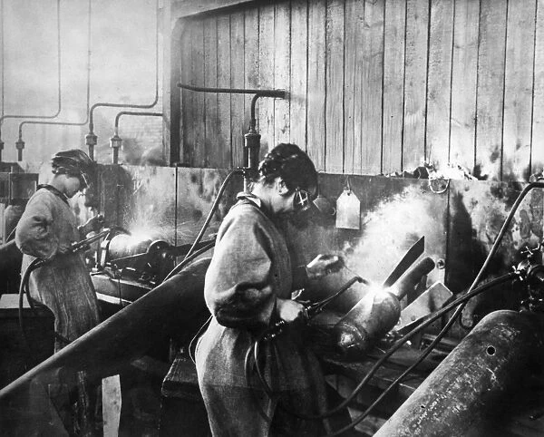 WORLD WAR I: WOMEN WORKERS. Women welding bomb casings in an American munitions factory, c1917