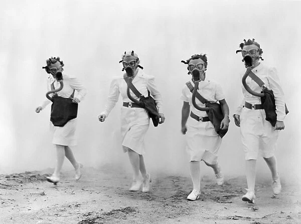 WORLD WAR II: NURSES. U. S. Army nurses advance through a cloud of smoke in a gas mask drill during training at Scott Field, Illinois. Photograph, c1942
