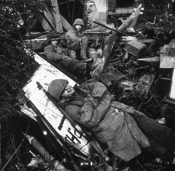 WORLD WAR II: RESTING. American troops resting among ruins of a building on the Siegfried Line