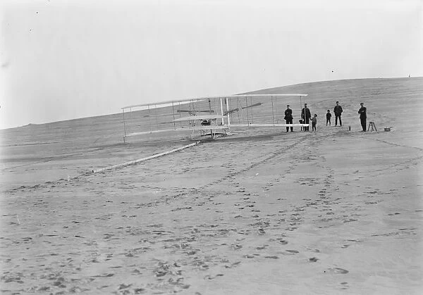 The Wright brothers flying machine at the launching track at Big Kill Devil Hill in Kitty Hawk, North Carolina. Photograph, 14 December 1903