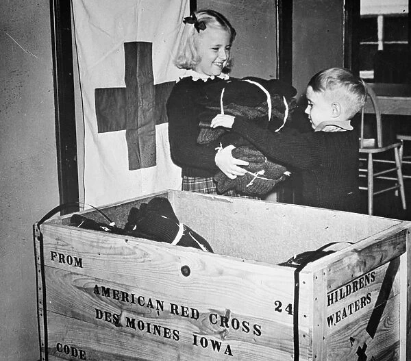WW II: RED CROSS, c1942-43. Members of the Junior American Red Cross packing childrens sweaters for war refugees in Europe. Photograph, c1942-43
