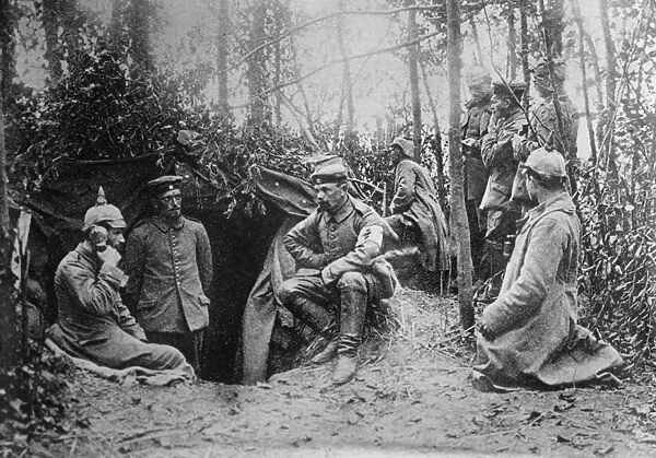 WWI: FIELD PHONE, c1914. German soldiers using a field telephone in a dugout. Photograph