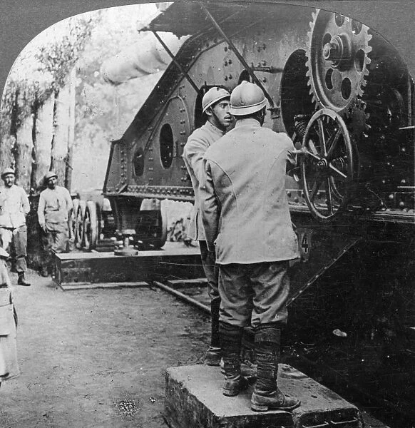 WWI: FRENCH GUNNERS, c1915. French gunners adjusting large cannon mounted on railway