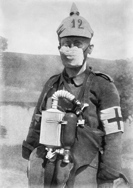 WWI: GERMAN SOLDIER, c1914. A German medic wearing a face mask to protect against gas attacks