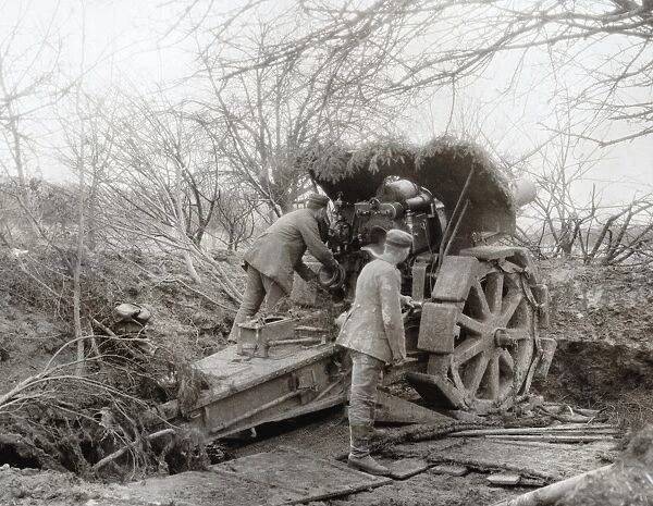 WWI: HOWITZER, c1915. Soldiers manning a camouflaged howitzer. Photograph, c1915