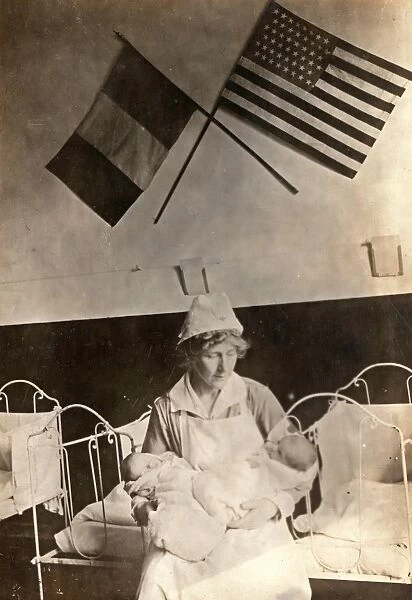 WWI: RED CROSS, 1918. A nurse caring for babies at the American Red Cross Childrens Home in Toul