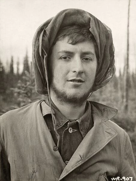 WWII: ALASKA, 1942. Private N. Calkins wearing a mosquito net during the construction