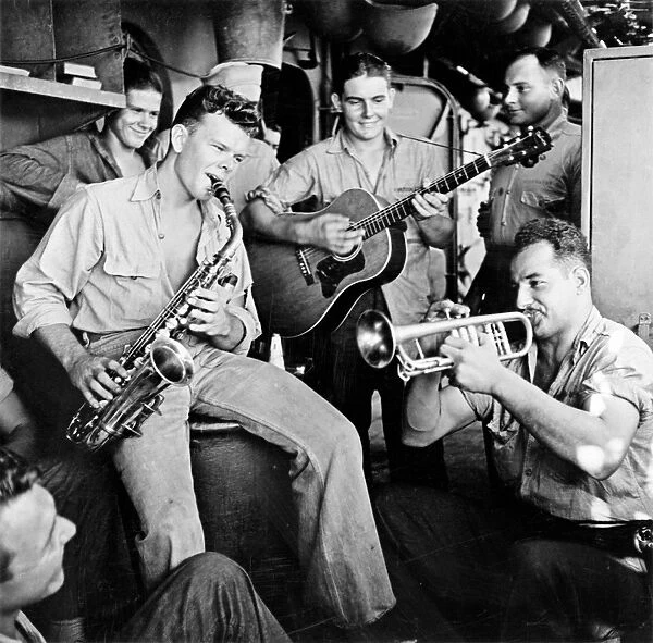 WWII: BAND, c1943. American servicemen playing music onboard an aircraft carrier