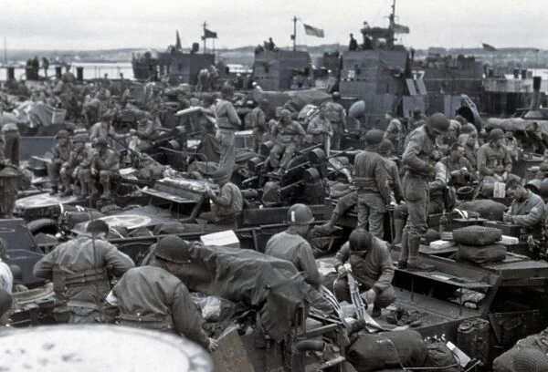 WWII: D-DAY, 1944. American troops and equipment on board a landing ship in a British port