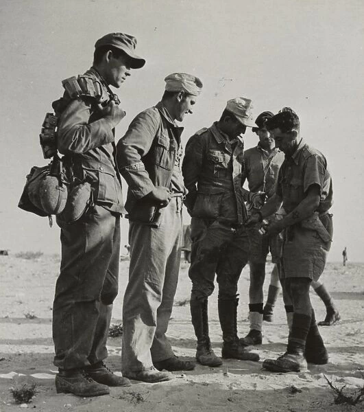 WWII: EL ALAMEIN, 1942. German Afrika Korps prisoners being searched after capture