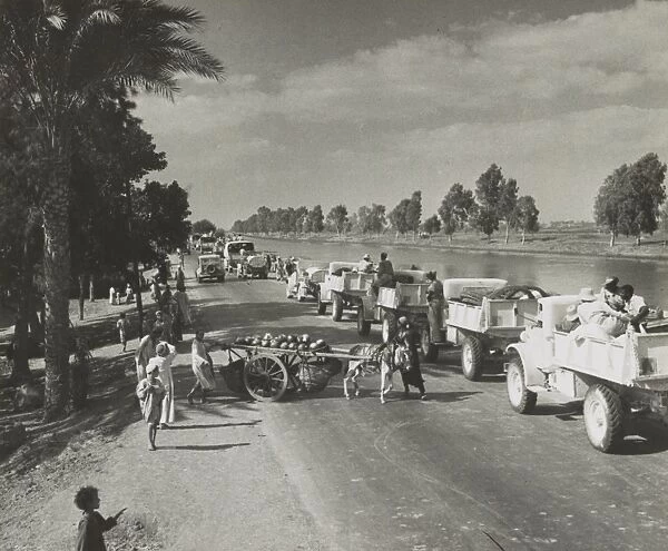 WWII: EL ALAMEIN, 1942. Long convoy of British military vehicles moving toward