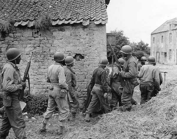 WWII: FRANCE, 1944. American troops preparing to eliminate a German sniper in a