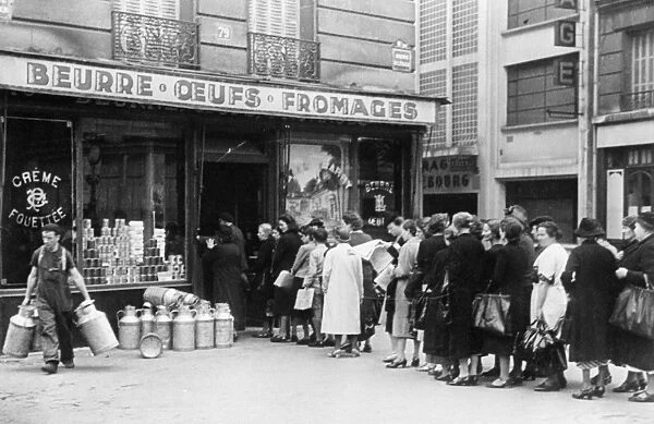 WWII: FRANCE, c1942. French women queuing outside of a grocery store in German-occupied France