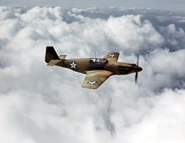 WWII: P-51 MUSTANGS, 1942. A P-51 Mustang fighter plane in flight over Inglewood, California