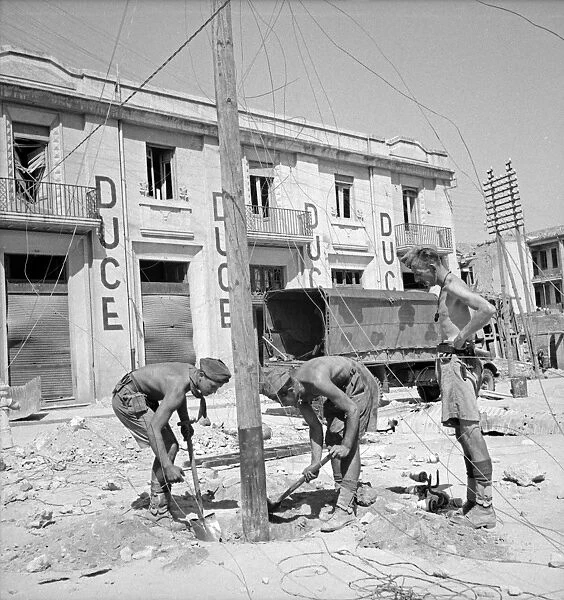 WWII: SICILY, 1943. British and Italian soldiers working to restore communication