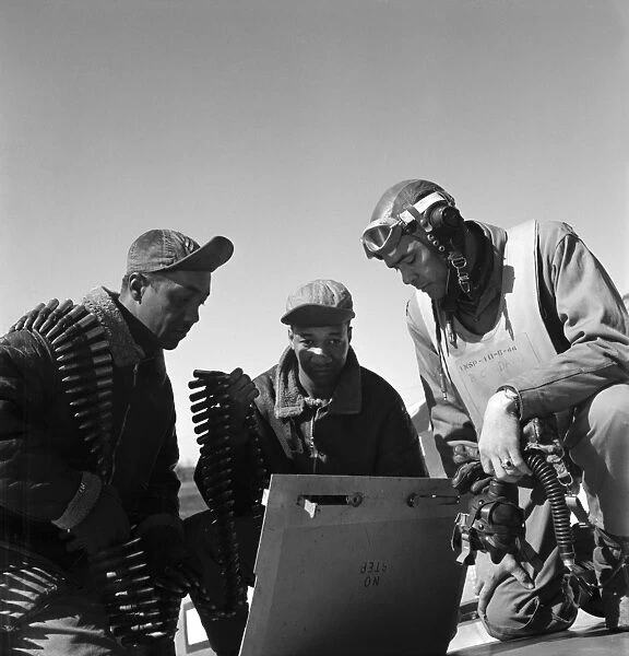 WWII: TUSKEGEE AIRMEN, 1945. Tuskegee Airment Roscoe Brown, Marcellus Smith and Benjamin Davis, with ammunition at Ramitelli Airfield in Italy. Photograph by Toni Frissell, March 1945