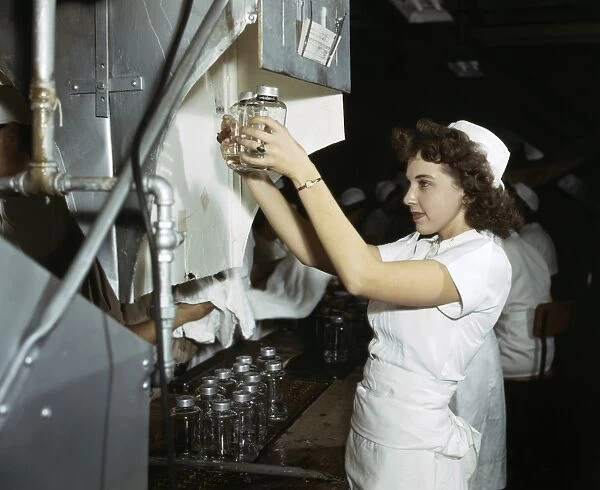 WWII: WORKERS, 1942. A worker with blood transfusion bottles at Baxter Laboratories in Glenview