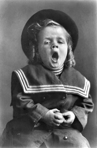 YAWNING, c1909. A small boy yawning. Photograph, c1909