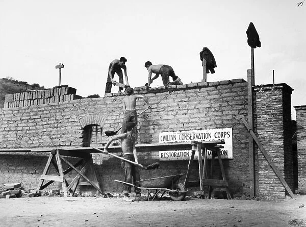 Young men in the Civilian Conservation Corps laying adobe bricks on the walls of a storage building at the Mission of the Immaculate Conception near Lompoc, California, September 1938