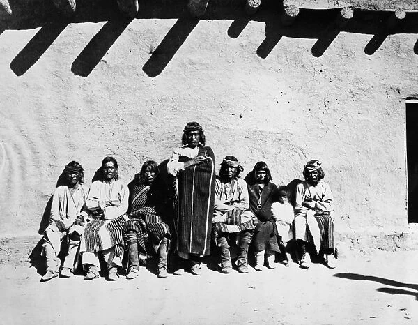 ZUNI GOVERNORS, 1879. Governors of Zuni Pueblo, New Mexico, outside an adobe structure