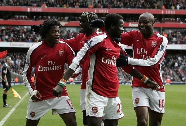 Triumphant Moment: Arsenal's Eboue, Gallas, and Song Celebrate 3rd Goal vs. Burnley in FA Cup