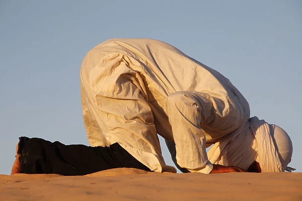 Beduin praying in the Sahara