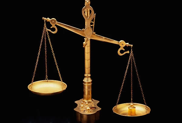 These are the golden Scales of Justice. They represent the legal system and courts. The scales here are shown unbalanced with the left side weighing heavier than the right. They are shown against a black background