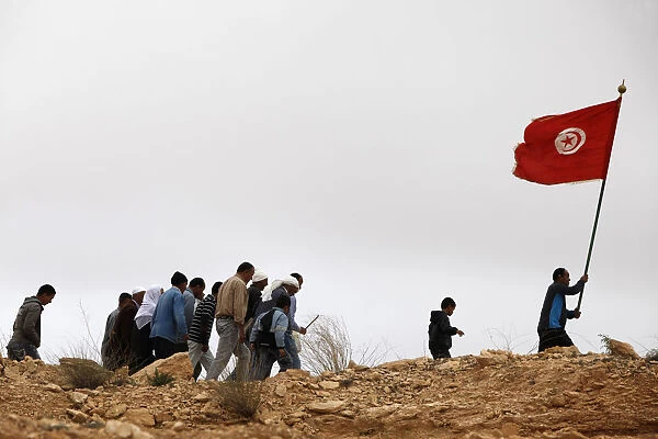 Group of Tunisian muslims walking up a hill