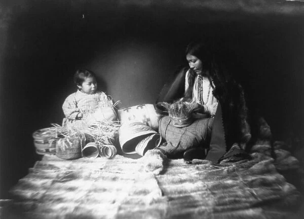 Indian woman and child weaving baskets