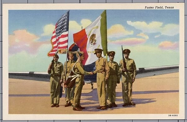 Mexico and United States Joining Forces. ca. 1943, Texas, USA, Foster Field, Texas. Aviation cadets and soldiers shake hands under the flags of the United States and Mexico to mark the joining together of Mexico and sister Pan American republics with the United States forces