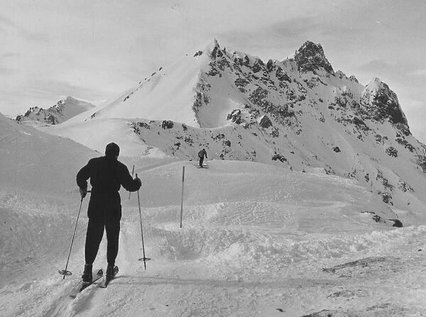No Lift. February 1955: Two skiers make their way up a marked trail on