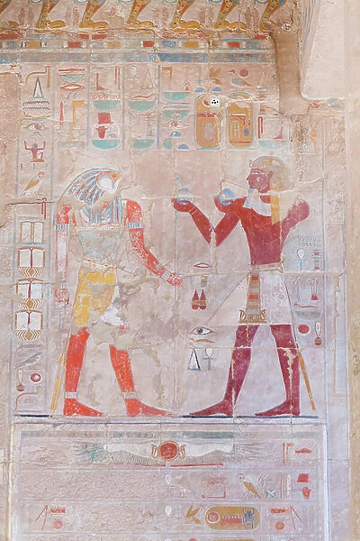 Bas relief picture depicting the pharaoh (on the right) making offerings to the God Horus, Hatshepsut temple of Deir Al Bahari, Luxor, Egypt (photo)