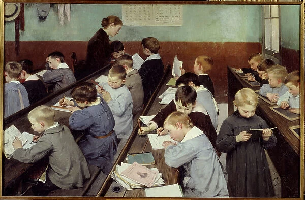 In class, the work of the little ones. Young boys in school blouse study in a classroom