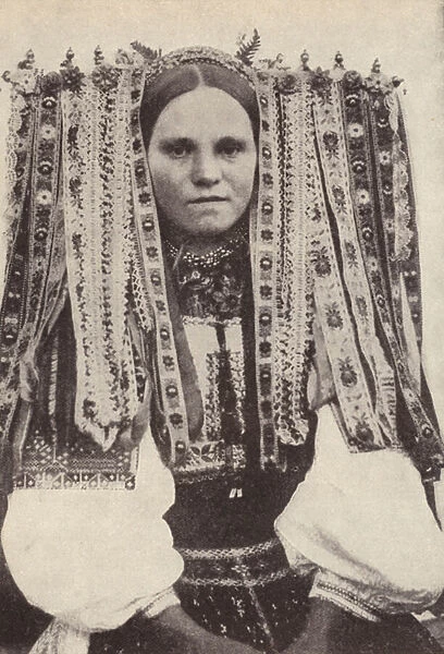 Czech woman wearing a headdress of ribbons where each ribbon denotes a suitor she refused in marriage (b  /  w photo)
