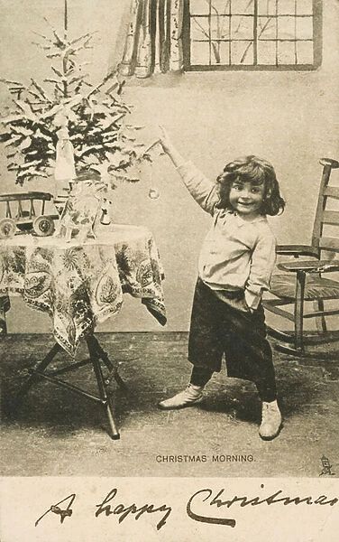 An excited young child on Christmas morning (b  /  w photo)