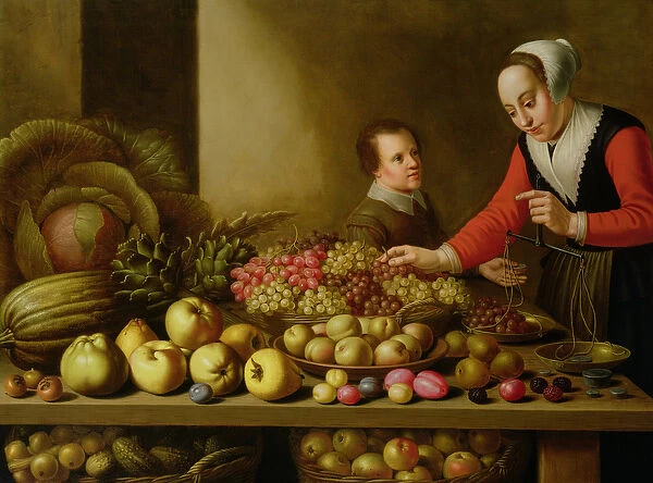 Girl selling grapes from a large table laden with fruit and vegetables