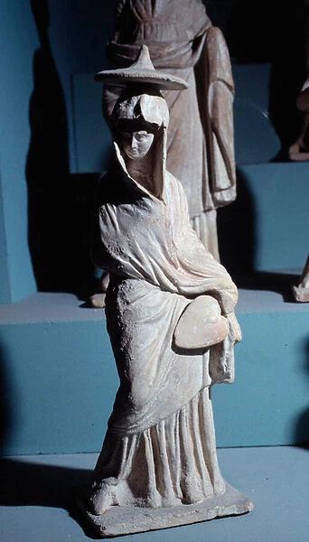 Terracotta figurines: woman standing draped with a fan, in the style 'Tanagreen'