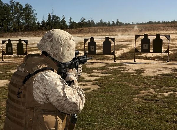 A military policeman fires a rifle at the shooting range