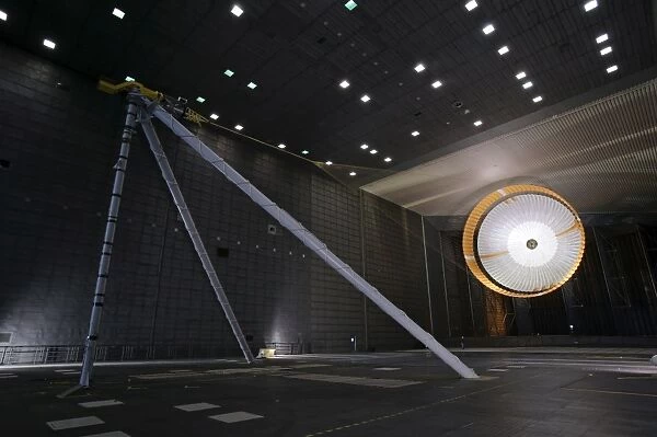 A parachute undergoes flight-qualification testing inside a wind tunnel