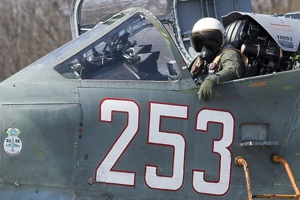 A pilot sitting in the cockpit of a Sukhoi Su-25 aircraft