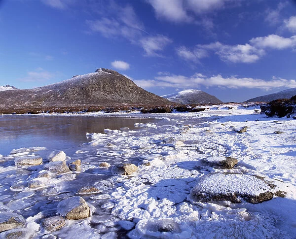 Lough Shannagh with light covering of snow on the beach and Doan peak in the background